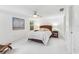 Bright bedroom with a ceiling fan, white walls, and a bed with decorative pillows at 250 Aberdeen St, Dunedin, FL 34698