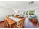 Large, bright dining room featuring mosaic tile flooring and views of lush backyard at 250 Aberdeen St, Dunedin, FL 34698
