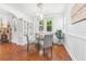 Bright dining area with wainscoting, glass-top table, built-in shelving and views of the backyard at 250 Aberdeen St, Dunedin, FL 34698