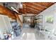 Unfinished garage space with exposed wooden beams, a concrete floor, and ample storage at 250 Aberdeen St, Dunedin, FL 34698