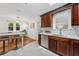 Kitchen showcasing stainless steel dishwasher, wooden cabinets, and marble counter with breakfast bar at 250 Aberdeen St, Dunedin, FL 34698