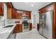 Updated kitchen features stainless steel appliances, white countertops, and classic subway tile backsplash at 250 Aberdeen St, Dunedin, FL 34698