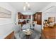 Open-concept kitchen featuring cherry cabinets, stainless steel appliances, and white subway tile backsplash at 250 Aberdeen St, Dunedin, FL 34698