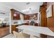 Kitchen featuring custom cabinets, white countertops, subway tile backsplash and modern stainless appliances at 250 Aberdeen St, Dunedin, FL 34698