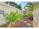 Lush landscaping with stepping stones lining the side of the home at 250 Aberdeen St, Dunedin, FL 34698