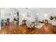 Spacious living room with hardwood floors, neutral decor, and seamless flow into the dining area at 250 Aberdeen St, Dunedin, FL 34698