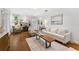 Cozy living room with hardwood floors, a stone fireplace, and comfortable seating arrangement at 250 Aberdeen St, Dunedin, FL 34698