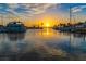 A beautiful marina view at sunset with boats and palm trees reflecting on the water at 250 Aberdeen St, Dunedin, FL 34698