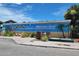 Charming mural with a 'Dunedin Welcomes You!' message with stylized beach scene and palms at 250 Aberdeen St, Dunedin, FL 34698
