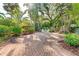 A private patio provides an inviting space for outdoor gatherings surrounded by lush foliage at 250 Aberdeen St, Dunedin, FL 34698