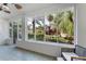 Relaxing screened porch offering serene views of the lush landscaping and providing a seamless connection to the outdoors at 250 Aberdeen St, Dunedin, FL 34698