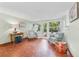 Inviting sitting room with mosaic tile floor, comfortable seating, and ample natural light from surrounding windows at 250 Aberdeen St, Dunedin, FL 34698