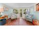 Bright sitting room with mosaic tile floors, white walls and comfortable seating at 250 Aberdeen St, Dunedin, FL 34698