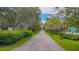 Scenic walking path lined with trees and greenery, creating a serene and inviting outdoor space at 250 Aberdeen St, Dunedin, FL 34698