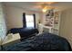 Bright bedroom with two twin beds, a ceiling fan, and a desk with shelving at 2700 Bayshore Blvd # 519, Dunedin, FL 34698