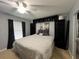 Stylish bedroom with a queen bed, built-in shelves, and black-out curtains at 2700 Bayshore Blvd # 519, Dunedin, FL 34698