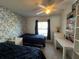 Bright bedroom with two twin beds, a ceiling fan, and a desk with shelving at 2700 Bayshore Blvd # 519, Dunedin, FL 34698