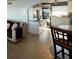 Open kitchen and living area featuring tile flooring, white cabinetry, and stainless steel appliances at 2700 Bayshore Blvd # 519, Dunedin, FL 34698