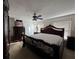 Cozy main bedroom featuring carpeted floors, a ceiling fan, and a large ornate bed frame at 2700 Bayshore Blvd # 519, Dunedin, FL 34698