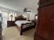 Comfortable main bedroom with carpet, a ceiling fan, and ornate wood furniture at 2700 Bayshore Blvd # 519, Dunedin, FL 34698