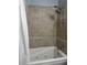 Shower featuring a tub, tile surround, and dual shower heads at 2700 Bayshore Blvd # 519, Dunedin, FL 34698