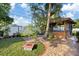 Landscaped backyard with tiled patio area and a cabana, perfect for outdoor living at 3309 W Ellicott St, Tampa, FL 33614
