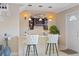 Charming bar area featuring a brick facade, overhead lighting, open shelves, and seating for two at 3309 W Ellicott St, Tampa, FL 33614