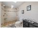 Bathroom with walk-in shower featuring elegant tile work, glass door and stone tile floor at 3309 W Ellicott St, Tampa, FL 33614