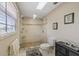 Bathroom with walk-in shower featuring elegant tile work, glass door, and stone tile floor at 3309 W Ellicott St, Tampa, FL 33614