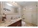 Elegant bathroom with a granite countertop vanity and a glass-enclosed shower with decorative tile at 3309 W Ellicott St, Tampa, FL 33614