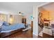 Bedroom with hardwood floors, ceiling fan, closet and view of guitars on the adjacent staircase at 3309 W Ellicott St, Tampa, FL 33614