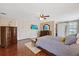 Bedroom features hardwood floors, closet, television, dresser, and neutral color palette at 3309 W Ellicott St, Tampa, FL 33614