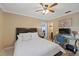 Inviting bedroom with a queen-sized bed, ceiling fan, workspace, and ensuite bathroom access at 3309 W Ellicott St, Tampa, FL 33614