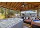 Relaxing cabana interior with hot tub, sofa, mini fridge and ceiling fan at 3309 W Ellicott St, Tampa, FL 33614
