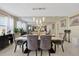 Chic dining room featuring a mirrored wall and modern chandelier with seating for six at 3309 W Ellicott St, Tampa, FL 33614