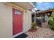Charming home with a red front door and a decorative tiled walkway leading to the cabana at 3309 W Ellicott St, Tampa, FL 33614
