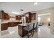 Modern kitchen with dark wood cabinets, granite countertops, and stainless steel appliances at 3309 W Ellicott St, Tampa, FL 33614