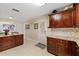 Updated kitchen featuring custom cabinetry and stone countertops with access to an exterior door at 3309 W Ellicott St, Tampa, FL 33614