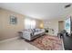 Bright living room showcasing a plush sofa, tile flooring, and neutral wall paint at 3309 W Ellicott St, Tampa, FL 33614