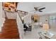 Inviting living room featuring stairs, bar seating area, and decorative wall art for a welcoming atmosphere at 3309 W Ellicott St, Tampa, FL 33614