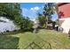 View of the cabana in the backyard with the well-maintained lawn and garden at 3309 W Ellicott St, Tampa, FL 33614