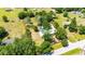 Aerial view of the property, showcasing the home, above ground pool, spacious yard and surrounding greenery at 3319 Fox Ridge Blvd, Wesley Chapel, FL 33543