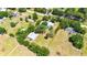 Aerial view of a home with a pool, expansive yard, and metal building, highlighted by a property outline at 3319 Fox Ridge Blvd, Wesley Chapel, FL 33543