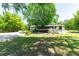 Lush backyard showcasing mature trees, a grassy lawn, an above-ground pool, and outdoor entertaining area at 3319 Fox Ridge Blvd, Wesley Chapel, FL 33543