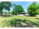Expansive backyard featuring mature trees, a volleyball net, above-ground pool and screened patio, perfect for entertaining at 3319 Fox Ridge Blvd, Wesley Chapel, FL 33543