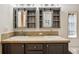 Bathroom vanity featuring double sinks, dark wood cabinets, and mirrors with storage at 3319 Fox Ridge Blvd, Wesley Chapel, FL 33543