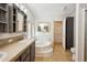 A bathroom featuring a soaking tub, cabinet with shelving, a toilet and neutral tile flooring at 3319 Fox Ridge Blvd, Wesley Chapel, FL 33543
