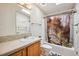 A bathroom featuring a bathtub with shower, a sink, a mirror and a toilet at 3319 Fox Ridge Blvd, Wesley Chapel, FL 33543