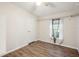 Bright bedroom featuring hardwood floors, a ceiling fan, a window, and closet at 3319 Fox Ridge Blvd, Wesley Chapel, FL 33543
