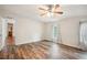Bright bedroom with wood-style floors, a ceiling fan, and a window with bright natural light at 3319 Fox Ridge Blvd, Wesley Chapel, FL 33543